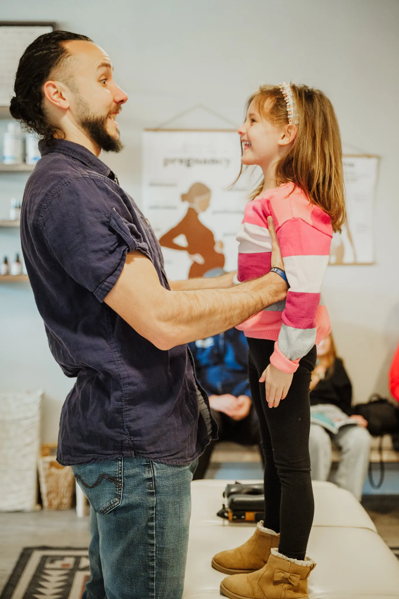 Doctor with happy child standing on table