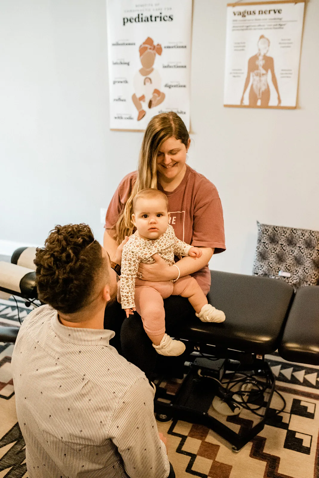 Doctor consulting with postpartum mom and baby